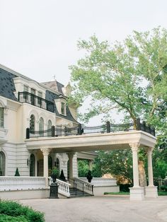 a large white house with columns and balconies