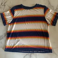 Super Comfy Soft Tee !!! Stripes Consist Of Dark Blue And Yellow/Orange Tones No Tags, Worn A Handful Of Times But Looks Brand New Fits Medium To Large Make An Offer Trendy Striped Rainbow Print Tops, Trendy Striped Tops With Rainbow Print, Trendy Rainbow Print Striped Tops, Casual Multicolor Rainbow Print T-shirt, Casual Multicolor Tops With Rainbow Print, Casual Multicolor Rainbow Print Tops, Casual Striped T-shirt With Rainbow Print, Retro Multicolor Tops With Rainbow Print, Multicolor Rainbow Print Graphic Tee