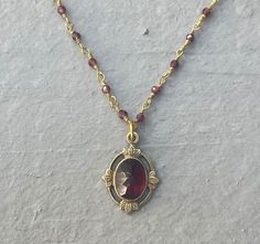 This vintage-inspired necklace is handmade using a 2mm genuine garnet wire-wrapped chain and a 12x17mm pendant with an authentic 6x8mm garnet stone.  This necklace is hypoallergenic. (Cadium free, lead free, and nickel safe) Garnet is an energizing stone that promotes passion and love.  The necklace comes in a hand-wrapped gift box, ready to be gifted. If you would like to leave a note for the recipient, you can do so during checkout. Please note that each stone is unique and varies in color. Garnet Necklace Vintage, Vintage Necklace Aesthetic, Unique Jewelry Vintage, Vintage Gold Necklace, Vintage Inspired Jewelry, 1 Tattoo, Inspired Necklace, Crystal Necklaces, Vintage Necklaces