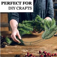 a person is making christmas wreaths with pine needles