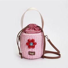 a small pink bag with a flower on the front