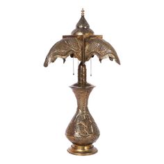 a gold colored lamp with two birds on it's top and one bird sitting on the base