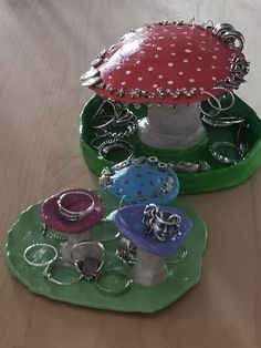 three rings are sitting on top of each other in front of a mushroom shaped tray