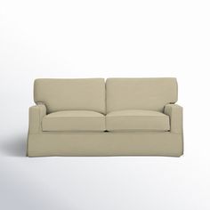 a white couch sitting on top of a white floor