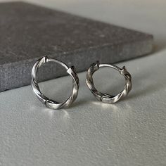 Introducing our Sleek Titanium Twist Hoops, the perfect accessory to elevate any outfit! These modern and chic earrings feature a unique twisted design crafted from high-quality titanium, ensuring durability and lightweight comfort. The sleek finish adds a touch of sophistication to your look, making these hoops versatile enough to wear from day to night. Add a contemporary twist to your jewelry collection with these stunning Titanium Twist Hoops! ▪️▪️▪️PRODUCT Sold by Pair, Each Pair=2pcs Easy Small Hoop Earrings With Modern Twist, Tarnish Resistant, Modern Twist Small Hoop Earrings Tarnish Resistant, Modern Twist Silver Earrings For Everyday, Everyday Silver Earrings With A Modern Twist, Silver Spiral Hoop Earrings For Everyday, Everyday Spiral Silver Hoop Earrings, Everyday Silver Spiral Hoop Earrings, Silver Hoop Earrings With A Modern Twist, Modern Twist Silver Hoop Earrings With Ear Wire