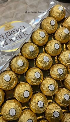 there are many chocolates wrapped in foil on top of each other with the words ferreto o'men written on them