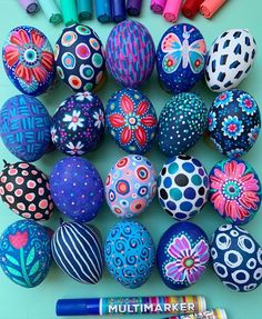 colorful painted eggs and markers on a table