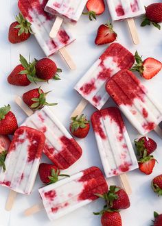 popsicles with strawberries on them are arranged on a white surface and green border