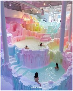 people are swimming in an indoor pool that looks like they've been made out of ice