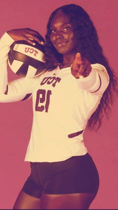 a female volleyball player is posing for a photo