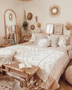 a bed room with a neatly made bed and mirrors