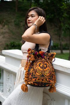 "The beautiful bag is made with an amazing piece of fabric woven by the HMONG hill tribes of (Northern Thailand). Its a great bag for carrying anything. It features a zippered opening area and inside zippered pocket. We buy materials from Hmong market and we design and sew by hand. Some of the bags we modify to improve the product. The Hmong tribes live in the North of Thailand Item Specifics Approximately Length : 13\" (INCH) Height : 14\" (INCH) Straps : 24\" (INCH) N.B. YOU MAY NOT RECEIVE TH Traditional Shoulder Bag With Tassels For Daily Use, Everyday Festival Bags With Tassels, Festival Bags With Tassels, Traditional Potli Bag With Tassels For Festivals, Traditional Shoulder Bag With Weaving For Festivals, Traditional Festival Bags With Tassels, Traditional Handmade Festival Bags, Traditional Embroidered Shoulder Bag For Festival, Bohemian Black Shoulder Bag For Festivals