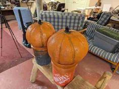 two pumpkins sitting on top of chairs in a room