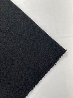 a black rug is laying on the floor