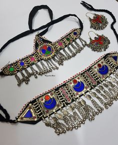 PRODUCT : 1 Vintage Necklace Choker Description This is an Afghan kuchi tribal choker necklace. It's an old handmade Afghan Turkish banjara vintage necklace. You can not go unnoticed at any occasion while wearing it. The back of the necklace has a black cotton cloth for a real comfort. On the top it's decorated with red and white beads. The filigree work is very intricate. The necklace has a black cord on each corner that ties at the back Its a beautiful peace of art created by the tribal people Bohemian Jewelry With Motifs For Festivals, Bohemian Necklaces With Motifs For Ceremonial Occasions, Bohemian Jewelry With Motifs For Party, Bohemian Necklaces For Rituals With Motifs, Bohemian Metal Choker For Festive Occasions, Bohemian Heavy Choker For Festive Occasions, Heavy Bohemian Choker For Festive Occasions, Traditional Handmade Choker For Festival, Bohemian Metal Choker For Ceremonial Occasion