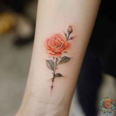 a small rose tattoo on the wrist