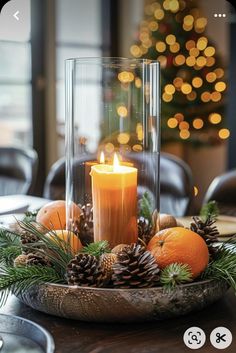 a candle and some pine cones on a table