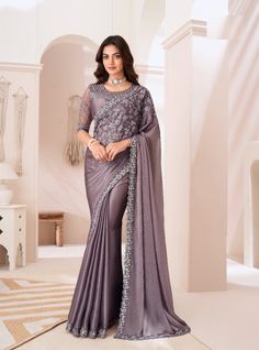 This luxurious designer saree is perfect for weddings and grand parties, combining elegance with modern style. The saree is crafted from rich Sartin Silk, known for its smooth texture and lustrous shine. Measuring 6.5 meters in length, it drapes gracefully, making it ideal for festive occasions. The highlight of this ensemble is the intricate thread and sequence embroidery work that adorns the saree, adding a sparkling touch that catches the light with every move. Paired with a matching blouse made from Sartin Silk Net, the blouse is also embellished with thread and sequence embroidery, offering a cohesive and stunning look. The combination of fine fabrics and detailed embroidery makes this saree a statement piece for any special occasion, ensuring you stand out with grace and sophisticati Gold Silk Saree, Saree Satin, Party Sarees, Greyish Brown, Embroidered Saree, Ready To Wear Saree, Ghagra Choli, Satin Saree, Brown Satin