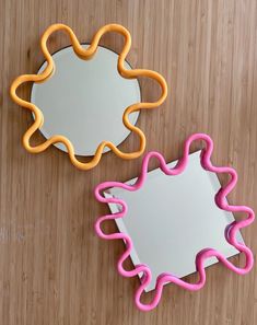 there are two cookie cutters sitting on the table next to each other, one is shaped like a flower