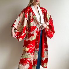 Minimal clean lines with a dramatic print! Vintage kimono features a white collar with draped sleeves. Fabric is composed of a bright red background with an abstract bonsai tree pattern made of orange, yellow, green, blue, and white hues. Orange silk lining. Please note: there is some discoloration at the collar and on the fabric. Please check photos provided. Heavy weight. No label. No stretch. Fabric content is silk. Kimono is in great condition. Freshly cleaned and ready to wear! Measurements Vintage Kimono With Kimono Sleeves, Red Printed Long Sleeve Kimono, Red Vintage Kimono For Spring, Vintage Red Long Kimono, Vintage Long Red Kimono, Vintage Red Kimono For Tea Ceremony, Red Long Sleeve Kimono With Floral Print, Red Floral Print Long Sleeve Kimono, Traditional Red Printed Kimono