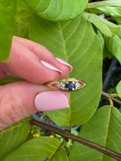 14k Vintage Sapphire & Diamond Ring Description: This 14k vintage ring features a stunning blue sapphire center stone accented by natural diamonds on either side. Currently sized at 5 3/4, it is resizable upon request. This dainty ring is perfect for stacking and adds a touch of elegance to any jewelry collection. Weighing 1.46 grams, it's a lightweight yet durable piece that can be worn daily or on special occasions. This piece, like all our jewelry, is a rare find—once it's gone, it's gone. Ch Vintage Blue Sapphire Ring With Diamond Accents, Vintage Sapphire Three Stone Ring, Vintage Sapphire Three Stone Diamond Ring, Vintage Sapphire Three-stone Ring, Sapphire Ring With Diamond Accents And Marquise Cut, Three-stone Diamond Sapphire Ring, Three Stone Sapphire Ring With Diamonds, Antique Oval Sapphire Ring With Diamond Accents, Oval Sapphire Promise Ring With Single Cut Diamonds