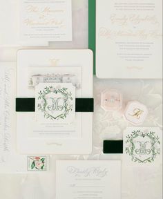 the wedding stationery is laid out on top of each other, including an envelope and ring box