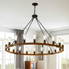 a large chandelier with many lights hanging from it's sides in a living room