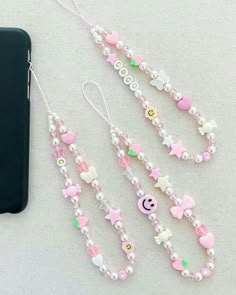 the phone case is next to some beaded necklaces