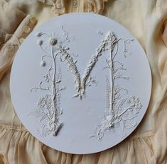 a white plate with the letter m on it