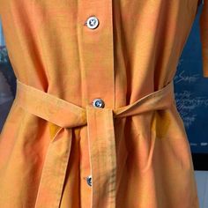 This is a beautiful and rare shirt dress / art dress from Finnish company Marimekko. Made in the 1969s (as the tag shows). 100% cotton. Marked as a Size 38. Fits a normal size Small, could also fit Medium. Good but not perfect condition, crispy cotton. One button (furthest down) is missing. A fixed scratch down on the front, see last pic. Sold as it is. Comes with a matching belt Orange with another Orange and Green in the pattern. Measurements, let me know if you need them. Yellow Button-up Cotton Dress, Yellow Cotton Button-up Dress, Yellow Cotton Shirt Dress For Spring, Summer Cotton Dress With Spread Collar, Fitted Cotton Shirt Dress For Summer, Orange Fitted Shirt Dress For Spring, Spring Orange Fitted Shirt Dress, Cotton Dress With Buttons And Spread Collar, Fitted Retro Shirt Dress For Summer