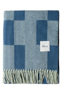 a blue and white checkered blanket with a tag on the side that says,