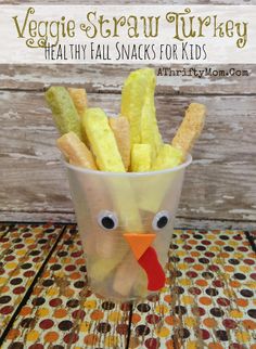 a plastic cup filled with french fries sitting on top of a table