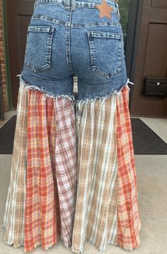 the back of a woman's jean shorts with plaid and stars on each side