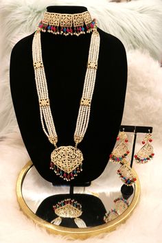 Handcrafted with love to give a real traditional look for this set beautifully studded with jadau stones and pearls give a royal look. Includes: Choker, Rani Haar, Earrings, and Tikka Bollywood Bridal Necklace With Pearl Drop For Festive, Bollywood Bridal Necklace With Pearl Drop, Festive Bollywood Bridal Necklace With Pearl Drop, Bollywood Style White Jewelry Sets For Eid, Temple Jewelry Sets With Pearl Chain For Celebration, Temple Jewelry Sets With Pearl Drop For Celebration, Festive Pearl Drop Jewelry Sets, Elegant Chandbali Jewelry Sets With Zari Work, Traditional Kundan Necklace With Pearl Chain For Celebration