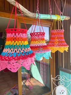 colorful crocheted baskets hanging from the ceiling