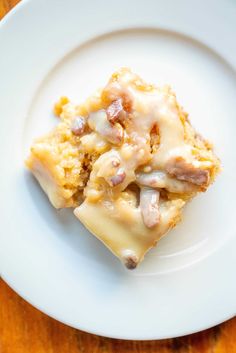 two pieces of cake sitting on top of a white plate next to a wooden table