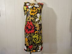 "Vintage 1960s mod dress. Made of multi color cotton. Has abstract flower pattern, back zipper and cotton lining. About a size large. Actual measurements are: 40.5\" around the bust 38\" around the waist 40.5\" around the hips 15.5\" shoulder to shoulder 37.5\" overall length In excellent unused condition. New old stock." Multicolor Cotton Mod Dress, Multicolor Mod Cotton Dresses, Abstract Flower Pattern, 1960s Mod Dress, Vintage Dresses 1960s, 1960s Dress, 1960s Mod, 1960's Dress, Dress Flower