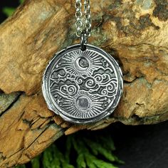 This pendant with sun, moon, stars and clouds exudes boho vibes and retro charm. It is an individually made one-of-a-kind piece made of 925 sterling silver and has a diameter of approx. 23 mm and is 2.72 mm thick. I will ship it in a matching jewelry box. You will receive exactly the pendant you see in the first photo. The other pictures are items from previous orders. They are similar, but are never 100% the same because they are handmade. I offer the pendant either with or without a chain. It Silver Pendant Jewelry With Sun And Moon Design, Vintage Sterling Silver Moon Phase Necklace, Celestial Jewelry With Sun Design Round Pendant, Silver Celestial Jewelry With Sun And Moon Design, Celestial Sun Design Round Pendant Jewelry, Silver Moon Phase Medallion Jewelry, Silver Celestial Necklace With Sun Design, Sterling Silver Sun And Moon Medallion Necklaces, Silver Medallion Jewelry With Moon Phase