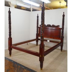 a wooden bed frame sitting in a room