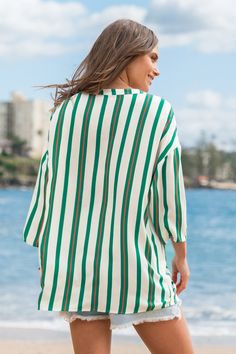 Looking for laid-back style with a pop of personality? The Green Vertical Stripe Half Sleeve Oversized Pocket Blouse has you covered. Its bold stripes and roomy pockets blend comfort with a touch of unique style, making it a go-to for effortless, everyday outfits. Product code: CAA04B4H032RC Features:  Woven Split neckline Drop shoulder Half sleeves Oversized breast pockets Pattern: Stripes Material: 100%RAYON. Striped V-neck Blouse For Vacation, Striped Blouse With Pockets Relaxed Fit, Striped Long Sleeve Blouse For Vacation, Striped Oversized Top For Day Out, Chic Beach Tops With Vertical Stripes, Striped Summer Blouse For Day Out, Striped Relaxed Fit V-neck Blouse, Striped Long Sleeve Summer Blouse, Casual Striped Beach Blouse