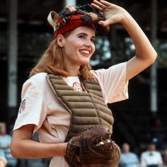 a woman wearing a catchers mitt on top of her head