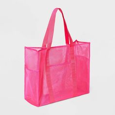 a pink tote bag sitting on top of a white table