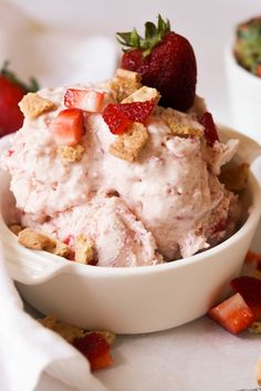 a bowl filled with ice cream and strawberries