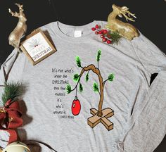 Long sleeve, 100% cotton t-shirt with Charlie Brown Christmas Tree and quote printed on chest. Charlie Brown Christmas Quotes, Diy Christmas Shirts, Brown Christmas Tree, Charlie Brown Christmas Tree, Brown Christmas, Charlie Brown Christmas, Christmas Quotes, Quote Prints, Charlie Brown