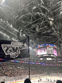 an arena filled with lots of people watching hockey