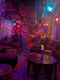 the inside of a bar with lights and decorations on the walls, couches and tables