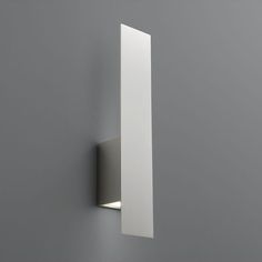 a bathroom mirror mounted to the side of a wall