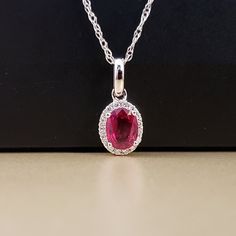 "Ruby and Diamond Pendant 14k White Gold pendant is featuring a 4.62X5.95mm Oval Genuine Ruby .69ct . This Beautiful Ruby has a Halo of .07ct Genuine Diamonds surrounding it. Classic and beautiful. **Ruby is the official July Birthstone** **Diamond is the official April Birthstone** **This listing is for the pendant only. Chain not included, for display purposes only. 14k Yellow Gold chains available for purchase upon request. **Please feel free to contact me anytime, if you have any questions o Halo Style, Ruby Pendant, April Birthstone, Halo Pendant, Gold Halo, Jade Ring, Star Ruby, Jade Jewelry, July Birthstone