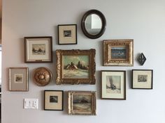 there are many framed pictures on the wall