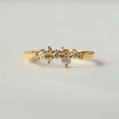 a gold ring with three diamonds on it